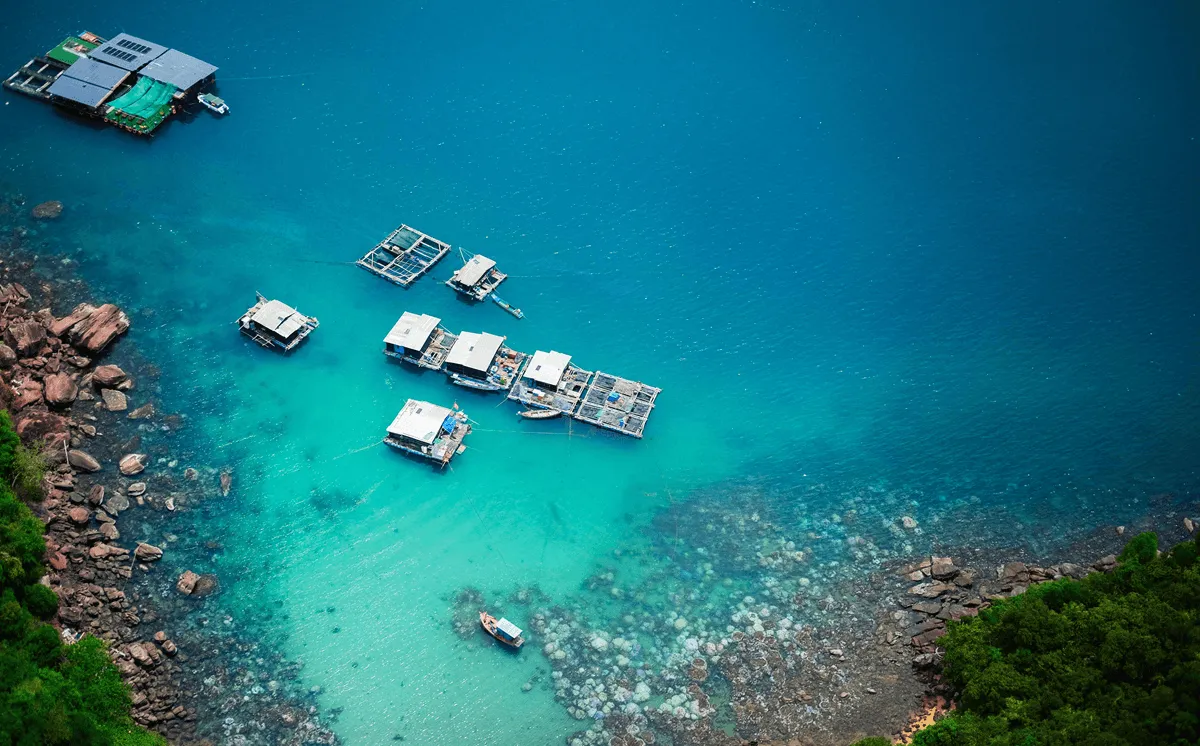 Aerial view of floating fishing houses in the clear turquoise sea off Phu Quoc