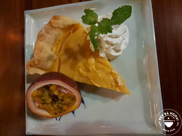 Passion fruit pie with whipped cream and mint